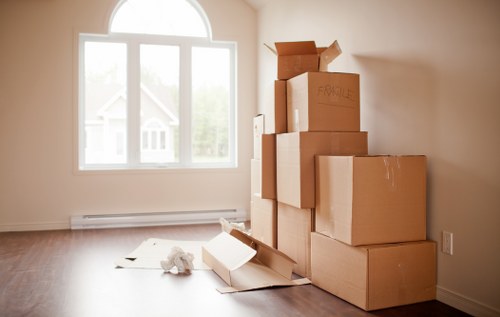 Packed moving boxes and protected furniture ready for transport