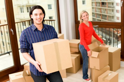 Local movers transporting desks and office items through a Lambeth commercial building